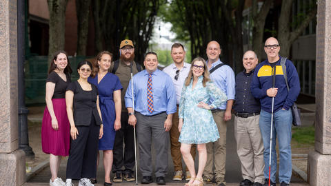 DAS poses smiling outside HKS. Left to Right: Jen, Suany, Jamie, Hunter, Kyle, John, Janell, Andy, Curtis, Erich.