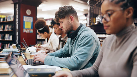 Young adults studying in a library.