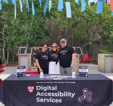 Suany, Janell, and Derek at the DAS table during Disability Pride. 