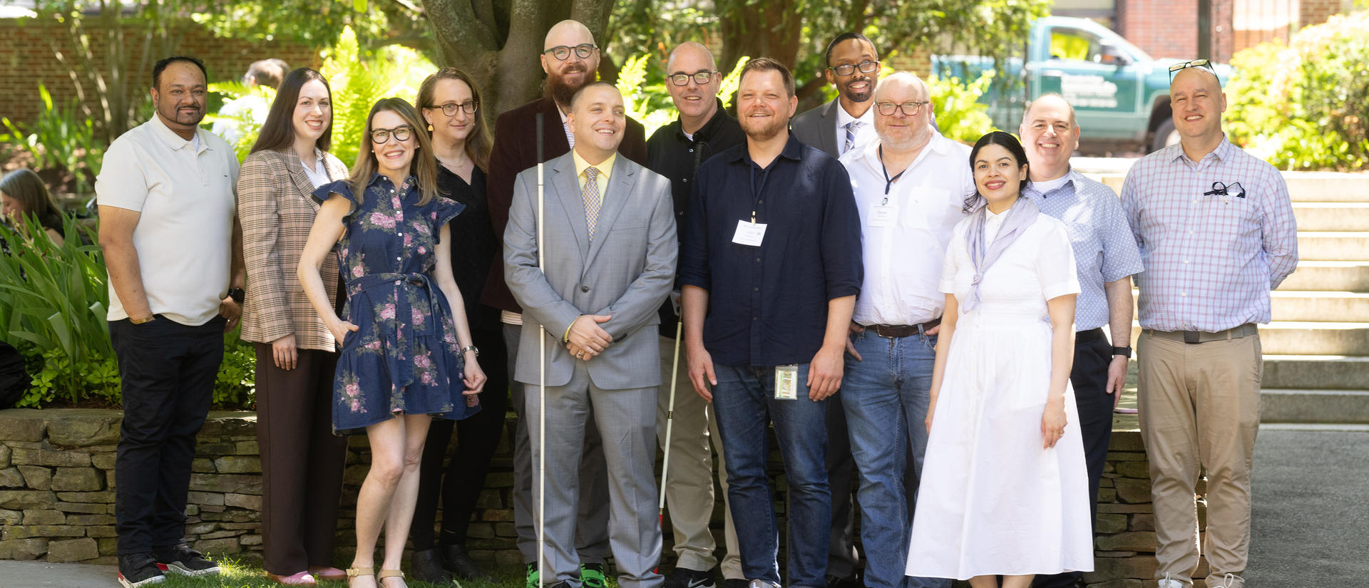 DAS team outside on a sunny day. Left to right: Caesar, Jen, Janell, Jamie, Hunter, Kyle, Erich, John, Evan, Derek, Suany, Curtis, Andy. 